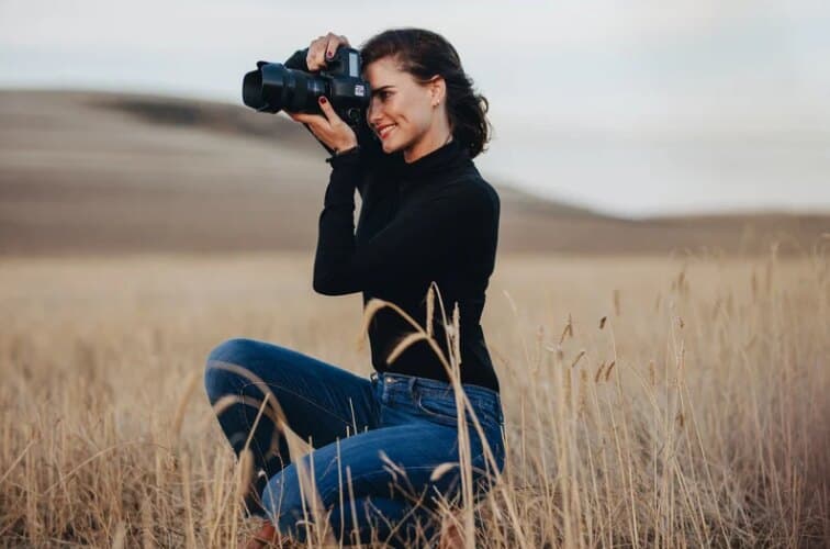 Videographer filming outdoors with a professional camera